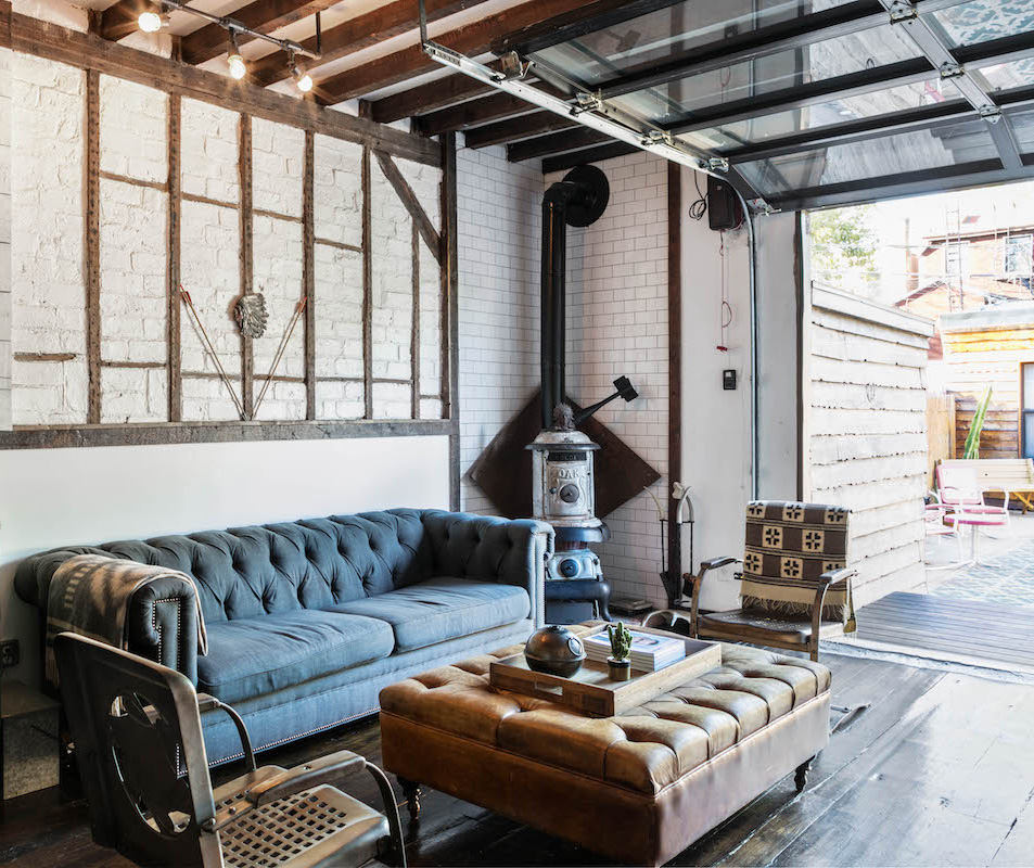 Lounge area with open garage door leading out of Urban Cowboy Brooklyn. These chairs and couch are just inside an area that leads out to our patio.