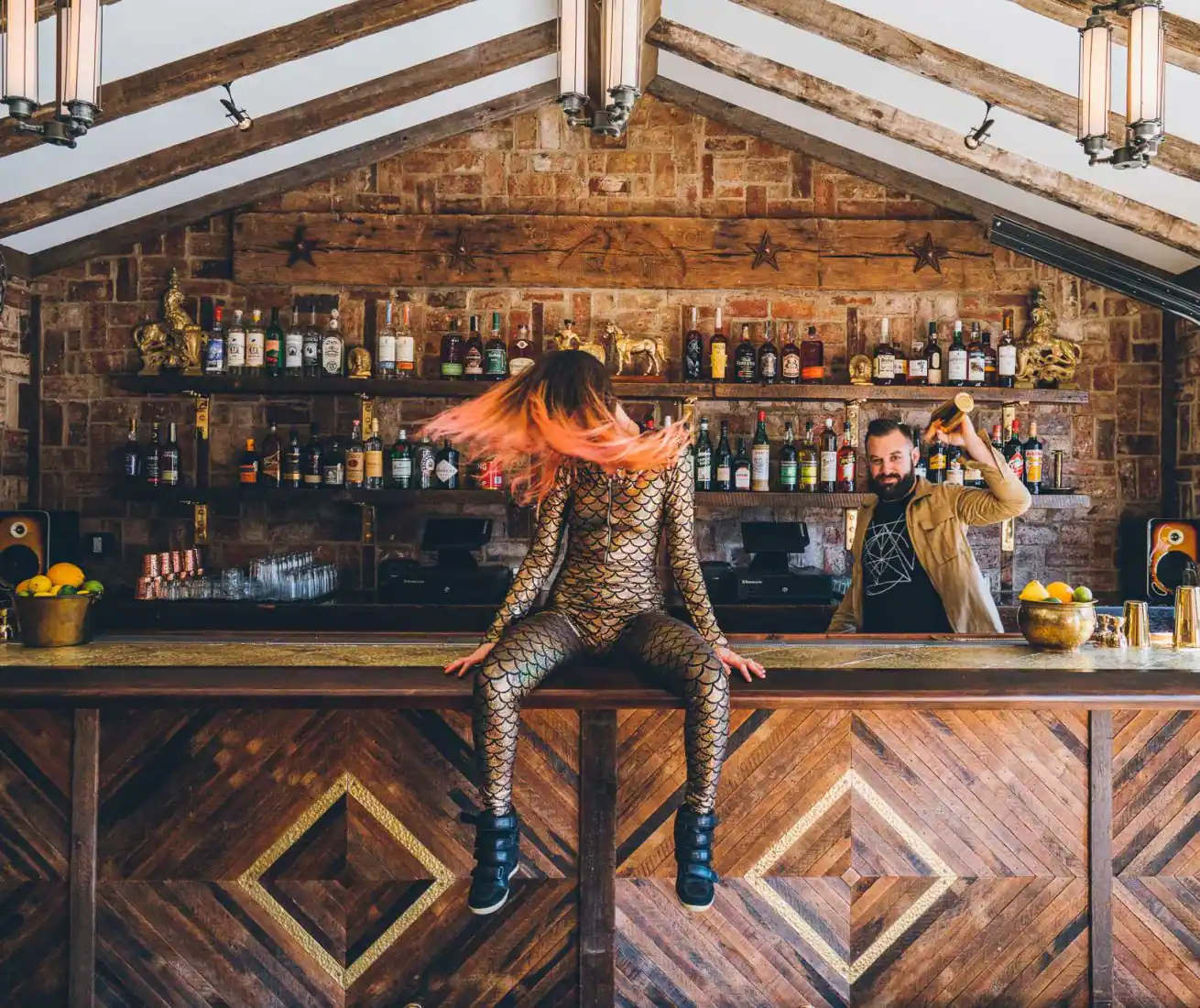 Orange haired dancer whipping her hair while seated on the bar of Public House. Photo by Dave Krugman.